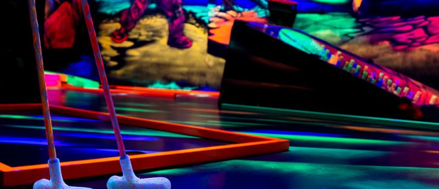 Black light heroes mini golf A section of a black light miniature golf course.