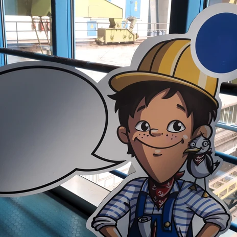 jpg (7).jpg Comicfigur eines Jungen mit gelbem Bauhelm und Möwe auf der Schulter in einer Industriehalle