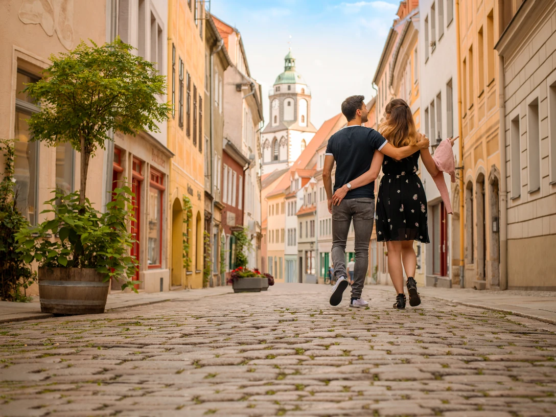 Spaziergang durch die Meißner Altstadt Ein Paar spaziert durch eine Kopfsteinpflasterstraße in der Meißner Altstadt.A couple walks along a cobbled street in Meissen's old town.Pár se prochází po dlážděné ulici ve starém centru Míšně.Para spaceruje brukowaną uliczką w centrum starego miasta w Miśni.Een koppel wandelt over een geplaveide straat in het oude stadscentrum van Meissen.Una coppia passeggia lungo una strada acciottolata nel centro storico di Meissen.