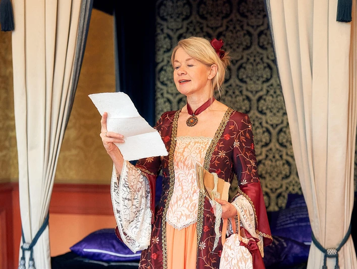 Kammerfrau Juliette liest historische Briefe im Celler Schloss Gästeführerin als Kammerfrau Juliette in historischem Kostüm liest einen Brief in einem prunkvollen Raum des Celler Schlosses
