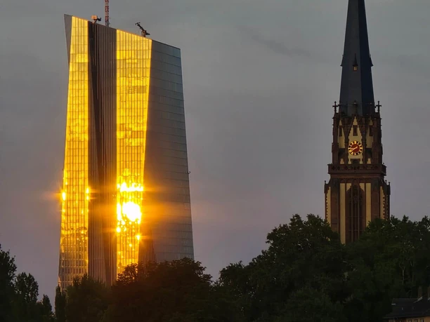 Sunset reflecting on the glass facade of a skyscraper in Frankfurt.