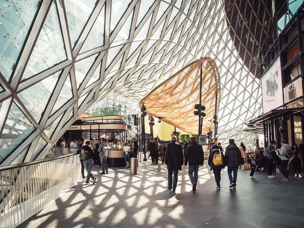 Foodtopia MyZeil Lichtdurchflutetes MyZeil mit markanter Glasstruktur und Besucher*innen