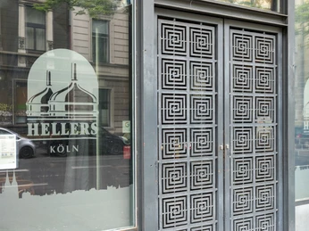 HELLERS Brewery Die Front eines Gebäudes mit großen Glastüren und Fenstern, verziert mit grafischen Mustern und Schriftzügen.The front of a building with large glass doors and windows, decorated with graphic patterns and lettering.