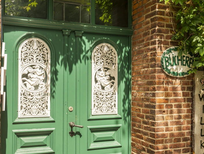 Eingangstür Bücherei Stelle Die kunstvoll bearbeitete grün-weiß Tür der Bücherei Stelle