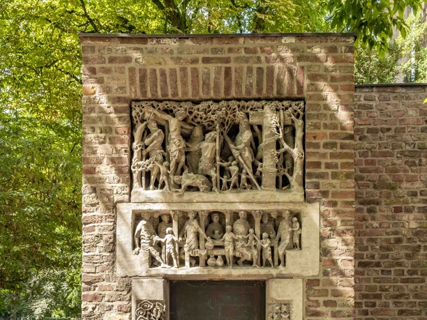 St. Alban A sandstone façade with elaborately designed reliefs lovingly frames a wooden door.