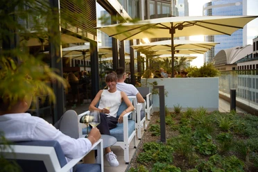 Lazuli Bar & Kitchen - Terrace Person sitting on terrace enjoying a drink.