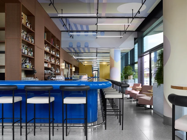 Lazuli Bar & Kitchen - Bar Modern bar with blue counter and high stools.