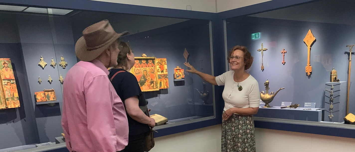 Curator Explains Ethiopian Icons and Crosses to Visitors at the Icon Museum in Frankfurt