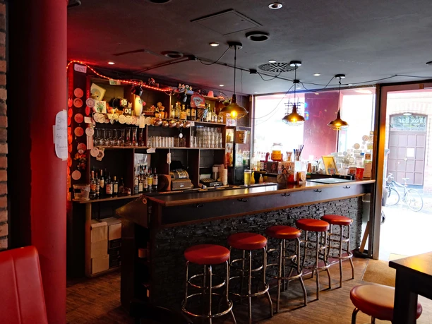Counter of the Red Fox Bar An atmospheric bar with a counter area, cozy lighting and metal bar stools.