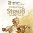 Eine vergoldete Statue eines Geigers mit floralem Hintergrund, beschriftet mit "Wiener Johann Strauß Konzert-Gala".