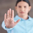 Stop, hand sign and woman with no gesture for sexual harassment and violence in workplace. Business professional, palm and female employee at company with stopping emoji for gender rights at job Stop, hand sign and woman with no gesture for sexual harassment and violence in workplace. Business professional, palm and female employee at company with stopping emoji for gender rights at job
