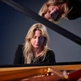 Ragna Schirmer Die Pianistin Ragna Schirmer vertieft am Flügel, mit einem reflektierenden Spiegelbild darüber.