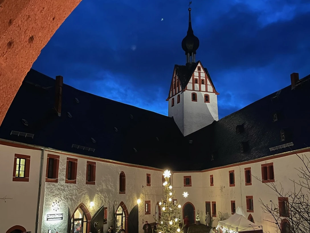 Adventsmarkt Schloss Rochsburg Zu sehen ist der stimmungsvoll geschmückte Hof von Schloss Rochsburg. Die Lampen am Weihnachtsbaum leuchten und es findet gerade der Adventsmarkt statt.You can see the atmospherically decorated courtyard of Rochsburg Castle. The lights on the Christmas tree are lit and the Advent market is taking place.Můžete si prohlédnout atmosféricky vyzdobené nádvoří hradu Rochsburg. Rozsvícená světla na vánočním stromu a probíhající adventní trh.Można zobaczyć nastrojowo udekorowany dziedziniec zamku Rochsburg. Świecą się lampki na choince i odbywa się jarmark adwentowy.Je kunt de sfeervol versierde binnenplaats van Kasteel Rochsburg zien. De lichtjes van de kerstboom zijn aangestoken en de adventsmarkt vindt plaats.Il cortile del castello di Rochsburg è decorato in modo suggestivo. Le luci dell'albero di Natale sono accese e si svolge il mercatino dell'Avvento.