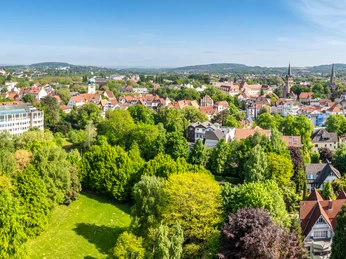 Herford-Aawiesenpark-Teutoburger-Wald-wfg-Herford-D-Ketz-150.jpg Panoramablick auf den Aawiesenpark in Herford, umgeben von grünen Wiesen und historischer Architektur.