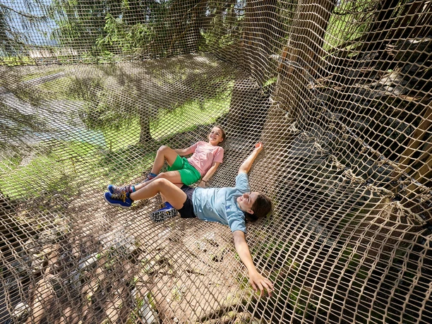 Wipfelpfad-Stockhütte-3.jpg Zwei Mädchen im Netz auf dem Wipfelpfad Stockhütte.