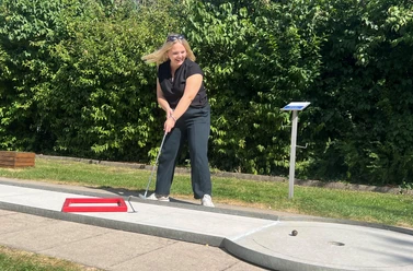 Besucherin spielt Minigolf