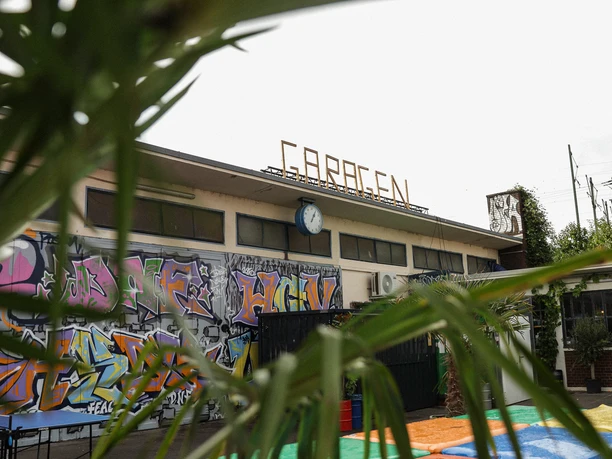 Garagen Club Auf dem Foto sind bunte Palettensitze, Graffiti und das urbane Ambiente des Garagen Clubs zu sehen.