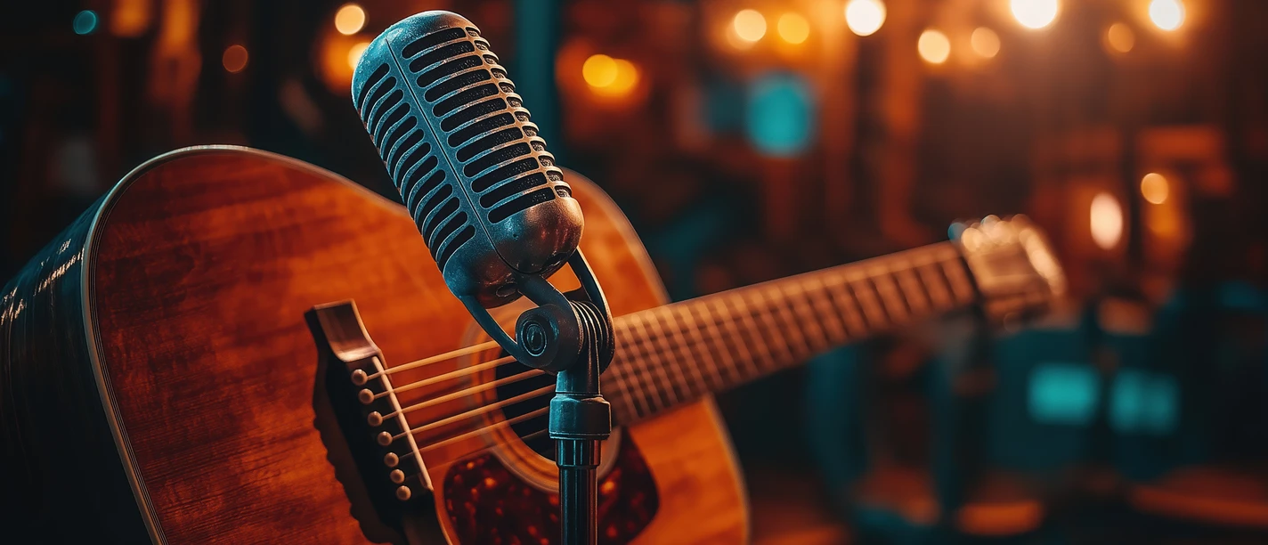 Vintage microphone and acoustic guitar in cozy music venue setting Vintage microphone and acoustic guitar in cozy music venue setting