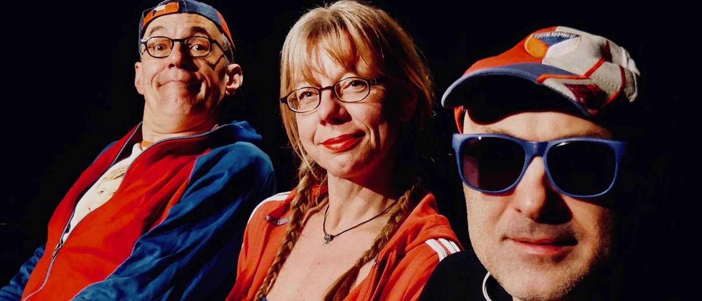 Three people in sportswear and sunglasses look smilingly into the camera against a black background.