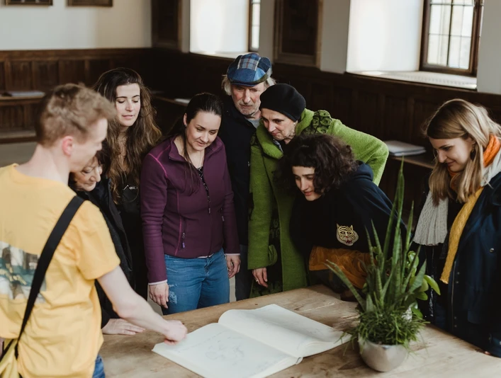 Rathaus- und Altstadt (Hauptbild).jpg Eine Gruppe interessierter Besucher studiert gemeinsam einen alten Stadtplan in einem historischen Gebäude.A group of interested visitors study an old city map together in a historic building.Een groep geïnteresseerde bezoekers bestudeert samen een oude stadsplattegrond in een historisch gebouw.