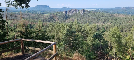 Ziegenruecken_view_to_the_Gamrig A vantage point from which you can see a forest, a rock massif and a table mountain.