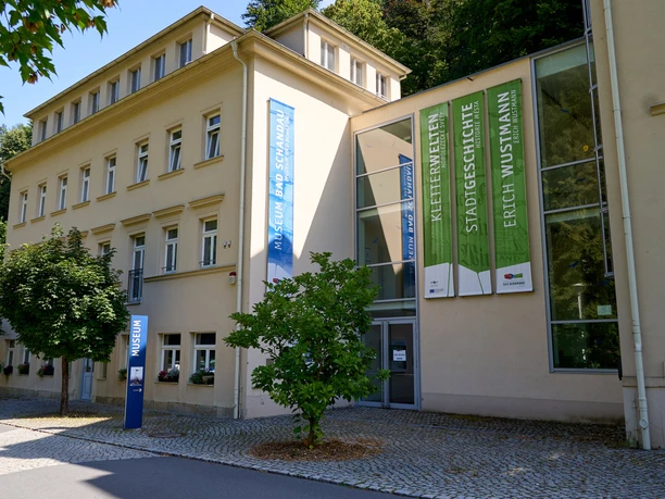 Yellow building with green banners.