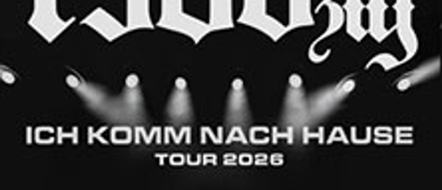 Schwarz-weißer Schriftzug "1986zig" über einer Konzertbühne mit einem Künstler vor einer Lichtermenge.