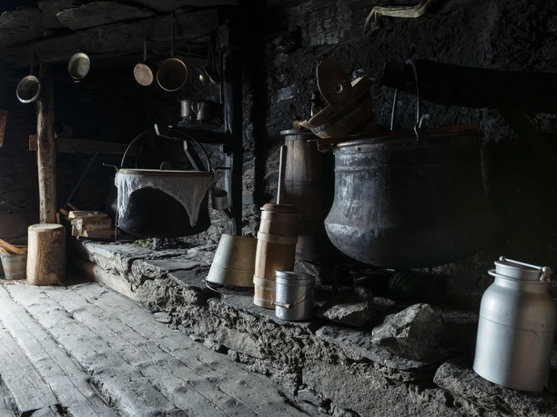 Old cauldrons and tools in the sennküche Show cheesemaking Alpmuseum Aletsch displays historic copper kettles and tools for traditional cheese making