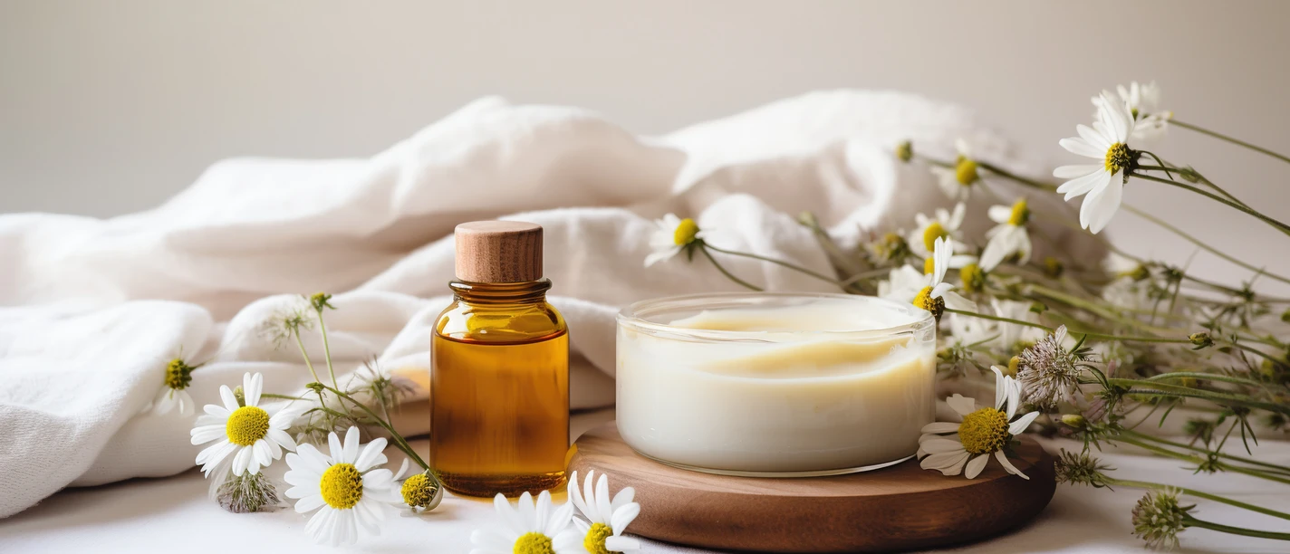 © Adobe Stock Self care card with organic cream, natural oil, aroma sticks, sleeping mask and wild flowers on white background.