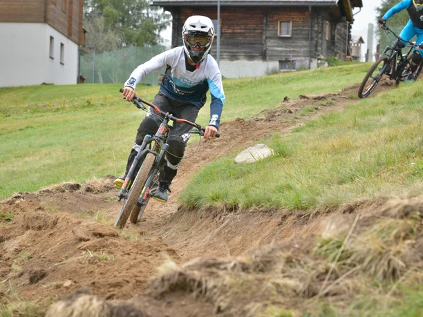 Young mountain bikers on a practice trail Children's bike course Riederalp with youngsters riding a practice trail on the Riederalp
