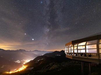 Milchstrasse über der Aletsch Arena Sternenfotografie Bettmerhorn mit Milchstrasse über dem beleuchteten Tal der Aletsch Arena und modernen PanoramarestaurantStar photography Bettmerhorn with Milky Way over the illuminated valley of the Aletsch Arena and modern panorama restaurantPhotographie en étoile du Bettmerhorn avec la voie lactée au-dessus de la vallée éclairée de l'Aletsch Arena et du restaurant panoramique moderne