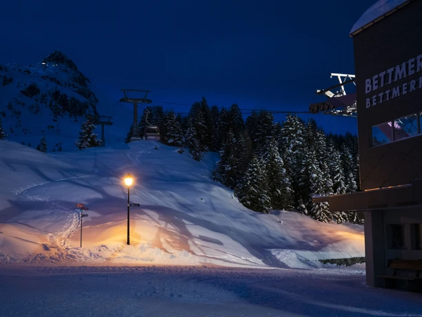 Mountain landscape of Bettmerhorn in the evening Bettmerhorn fondue gondola with snow-covered mountain station and gondolas in a wintery night-time atmosphere