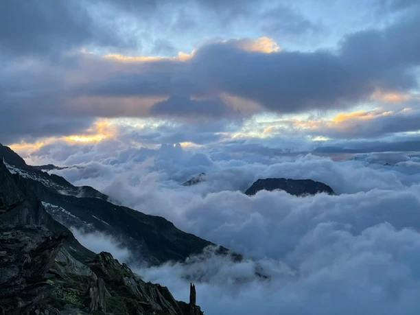 Morning atmosphere over the Aletsch Arena Night hike Bettmeralp Belalp with a view of the mist-covered mountains in the first light of day over the Aletsch Arena