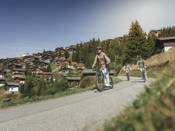Scootering through the Bettmeralp Adventure Pass Aletsch Arena with friends on a scooter through the car-free mountain village of Bettmeralp on a sunny summer's day