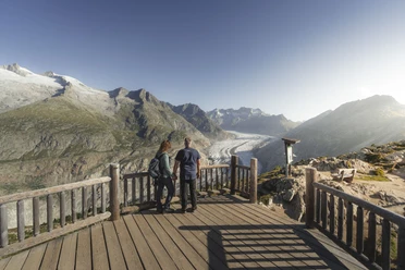 Panorama of the Aletsch Glacier Aletsch Discovery Pass with couple at the Moosfluh viewpoint with a view of the Great Aletsch Glacier