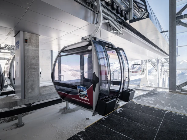 Winter in the mountain station Single rides Aletsch Arena with gondola in the modern mountain station during snowfall in the Aletsch Arena