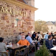 Market hall in Kassel in summer People sit on the terrace in front of the market hall in summer.