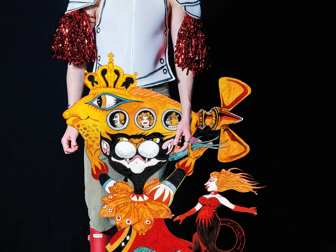 Kater mit Tim.jpg Das Bild zeigt einen männlichen Schauspieler, der eine Art Kuscheltier-Katze in der Hand hält