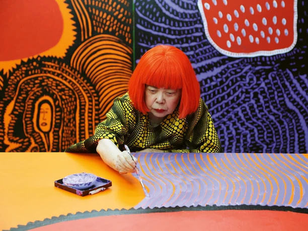 Yayoi Kusama working on My Eternal Soul (2009-21), 2017 Artist Yayoi Kusama works intently on her colorful painting.