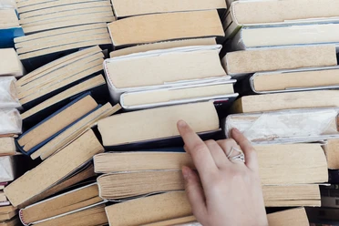 person-choosing-books-bookstore