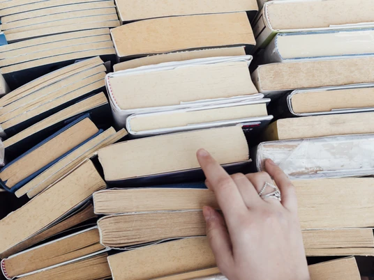 person-choosing-books-bookstore