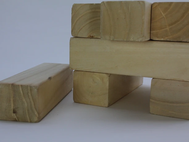 TeamOlympics - wooden building blocks Stacked wooden blocks on a white background.