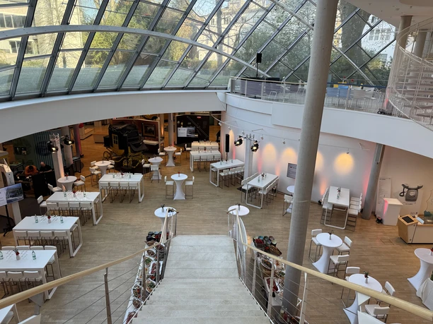 Museum for Communication Frankfurt - Glass roof Museum atrium with glass roof and tables.