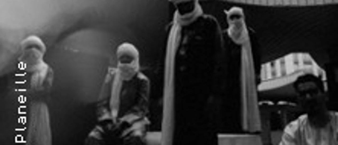 Gruppe von Musiker:innen in traditioneller Kleidung unter freiem Himmel vor Hochhäusern.