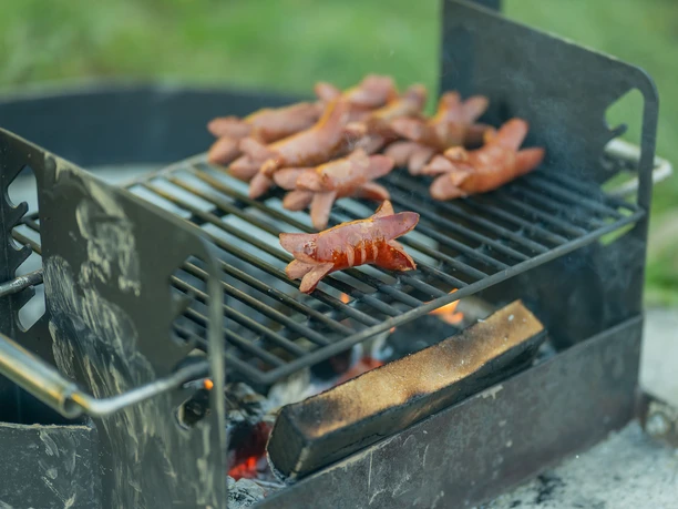 Modern barbecue at the GrimmiJutz barbecue area Post 4 Beautifully roasted Cervelat sausages on the grill rack