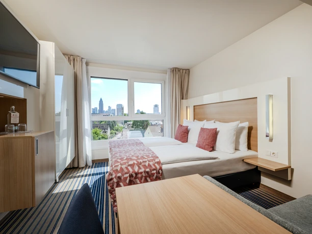 Best Western Plus Welcome Hotel Frankfurt - Hotel rooms Bright hotel room with a view of the skyline.