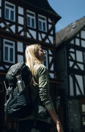 Rothaarsteig-Wanderin vor den Fachwerkhäusern von Dillenburg