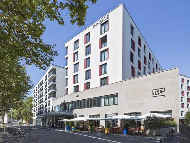 INNSiDE Frankfurt Ostend - Hotel building Modern hotel building with white façade and red accents.