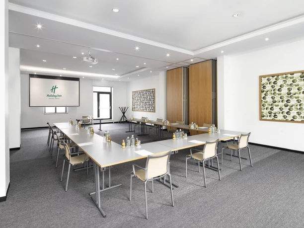 Holiday Inn Frankfurt - Alte Oper - Euro_Dollar Heller Tagungsraum mit U-Tisch und Leinwand.