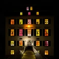 Advent calendar at the Holzhausenschlösschen Beleuchtetes Haus mit farbigen Adventsfenstern und Schattenfiguren.Illuminated house with colorful Advent windows and shadow figures.
